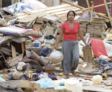 A woman salvages a few of her belongings from the ruins of her house, smashed by the tsunami when it hit the town of Moratuwa, south of Colombo on the island nation of Sri Lanka. Photo - Paul Jeffrey/ACT International
