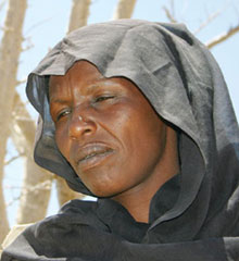 Hadjé Simine, 37 years old, a refugee from Korney in West Darfur, near her tent at Iridimi Camp. 'Even the clothes I had on burned when the Janjaweed attacked my village. I tried to find all my children during the attack, but I didn't succeed. I lost three of them, and I don't know if they are dead or alive.' Photo - Bjarne Ussing, DanChurchAid/ACT International