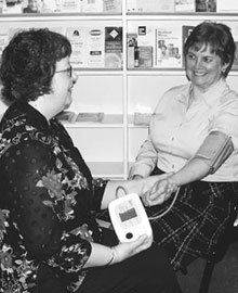 Beth MacKay Reilly, parish nurse and director of programs at Central Presbyterian Church in Hamilton, Ont., checks Patricia Oosterveld's blood pressure. Photo - Laura Barnard