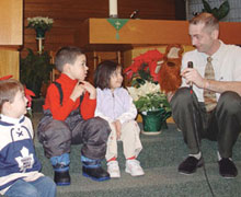 Benjamin, Damien and Zahra listen to Griffin the moose and his friend Rev. John Ufkes.