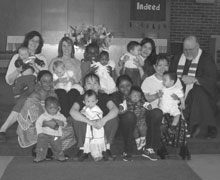 Mother's Day at First Church, Thunder Bay, Ont. Between February 2004 and January 2005 nine babies were born to the church family. The babies are of Caucasian, Burmese (Karen and Chin) and Sierra Leonian parentage, who came to Canada through the church's refugee sponsorship program. The moms and babies are with Rev. Mark McLennan.