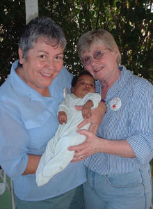 Marg Furtah and Mary Pat Elliott hold the Haitian baby their church sponsors.