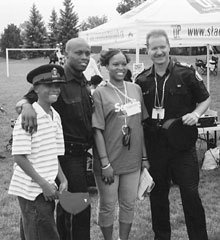 Toronto police officers pose with Tammy Taylor, one of the chief organizers of Celebrate Us.