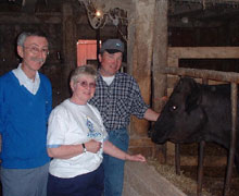 Wallaceberg's 'holy cow' with, from left, Clerk of Session Carl Maclean, Mary Pat Elliott and the cow donor, Wayne Robertson.