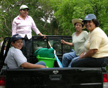 Antunez, far right, with colleagues, on the back of a truck, which is used to access remote communities.