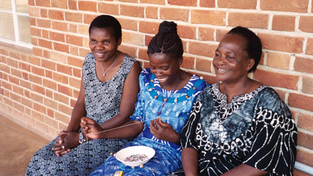 The superwomen: Esther Lupafya, Maria Silo and Grace Chunda make AIDS ribbon pins. Grace was hired with the support of funds raised through the PCC's Toward a World Without AIDS campaign.