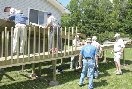 Members of Calvin, North Bay, build a wheelchair accessible ramp as part of a community work project.