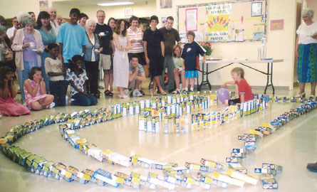 Church school kids play with Kraft Dinner boxes that were collected for a food bank project by St. Giles', St. Catharines.