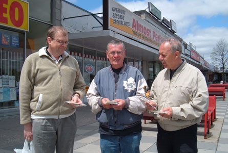 Volunteers gather to give out seed packets in May. Left to right: Dennis Cook, minister, Tom Aitkenhead and Terry Nicholls, volunteers.