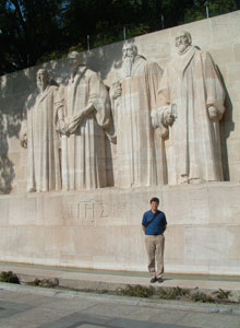 Will Ingram stands at the foot of theologians William Farel, John Calvin, Theodore Beza and John Knox at the Reformation Wall in Geneva.