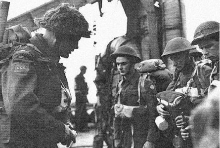 Padre Robert Seaborn praying with soldiers hours before the D-Day landings, June 6, 1944.