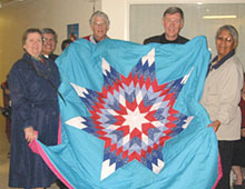 St. Andrew's and St. Paul's visitors received the Saskatoon Native Circle Ministry quilt in April. Left to right: Judith Kashul, Rev. Stewart Folster, Keith Randall, Don Walcot and Corine Eyahpaise.