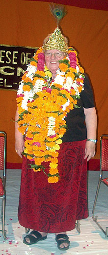 The Moderator decked out the Indian way: with a peacock feather capping her crown and a garland of marigolds and roses.