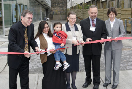 Cutting the ribbon to inaugurate the new Evangel Hall building on Adelaide St. West, in Toronto. From left: Sean Gadon, Director, Partnerships, Affordable Housing Office, City of Toronto; resident Khatija Tammi and her son Keith; Joe Taylor, Executive Director; Rev. Karen Bach, President, Board of Directors; Beverly Bowman, Director, Service Canada. Photo - Abel Pandy