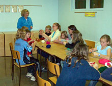 Right: Grade 4, 5, and 6 students learning to crochet at a weekly family time session at Knox, Waterloo.
