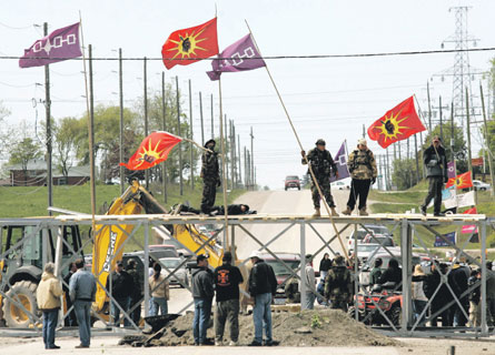 Six Nations protestors stand at the barricade in Caledonia, Ont., near Hamilton last May. Photo - CP Picture Archive/Nathan Denette