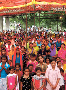 At church services in India, men and women sit separately. An outdoor service in Amkhut, pictured here, celebrated the release of the Bhil prisoners who were wrongfully imprisoned following a local uprising.
