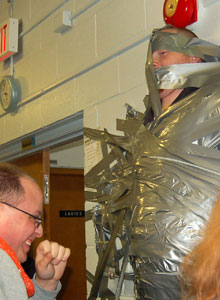 Dave Jansen, or "Duct Tape Dave", a youth leader at the event, is duct-taped to the wall to signal a covenant with God.