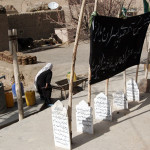 Flags mark the dead on a family compound