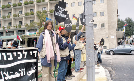 Paris Square, West Jerusalem. This Israeli chapter of Women in Black (an Argentinean movement) has gathered every Friday since 1998. The woman looking at the camera is a magistrate from England serving as an Ecumenical Advisor.