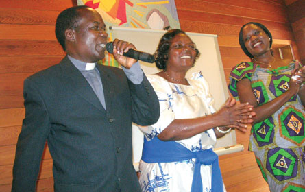 Rev. Sam Lwere and Deborah Ssengendo of St. Stephen's Church, Mpererwe, Uganda, sing a song of praise in celebration of the renewal of a partnership with St. Cuthbert's, Hamilton, Ont., while visiting in September. The partnership serves to support orphaned children in St. Stephen's parish. More information: <a href="http://stcuthberts.ca" target="_blank">stcuthberts.ca</a>.