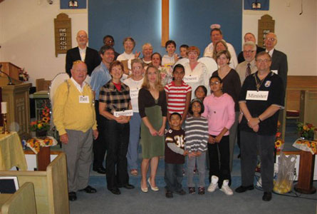 What were three angels doing at St. Timothy's on Thanksgiving Sunday 2008? The Angels of Thanksgiving Present, Past and Future were among the large cast participating in the drama, Thanksgiving is Thanksliving, written and produced by June Stevenson. The angels helped the minister, the Rev. Dennis Cook, pictured first row, right, to see the many things he and the congregation have to be thankful for.