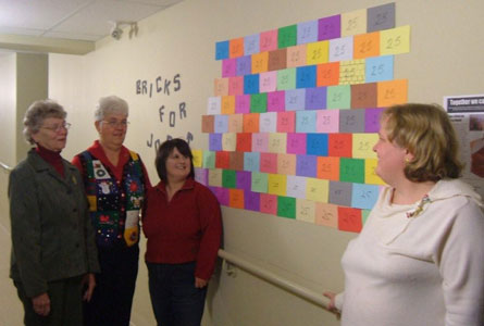 The Mary & Martha Society of St. Andrew's, Strathroy, held its sixth annual Christmas Extravaganza in November.  The mission for this year was bricks for the hostel in Jobat, India, and with proceeds of $2,250, enough money was raised to purchase 90 bricks! Pictured beside the "wall of bricks for Jobat" are Hilde Morden (President), Joan Wagner (Past President), Virginia Campbell (Secretary and Extravaganza organizer) and Kathy Boose (Treasurer).