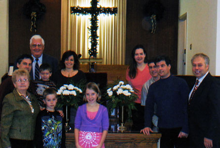 New St. Andrew's, Dover, in Chatham Kent, Ont., remembered Dave Millard, who died too early from injuries suffered in an accident, with a pair of engraved brass flower urns. From left: Dave's wife Janet Millard; brother Bob Millard; Pastor Mark Aarssen; along with other members of the Millard family.