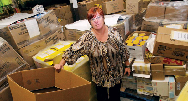 Gail Nyberg, executive director of the Daily Bread Food Bank, stands amid boxes at the facility in Toronto. Food Banks Canada is urging the federal government to help the poor with tax breaks as the country heads into a recession. Photo by cpimages.com