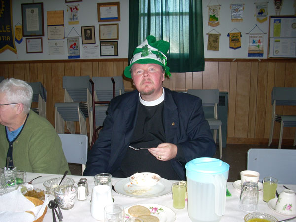 At a different event, on a similar theme, we see Charles McPherson, Clerk of Pictou Presbytery, eating dessert at a St. Patrick's Day lunch, Westville, N.S.