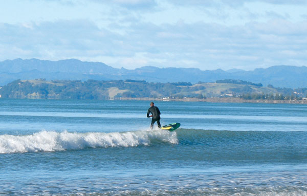 Surfing at Ohope Beach