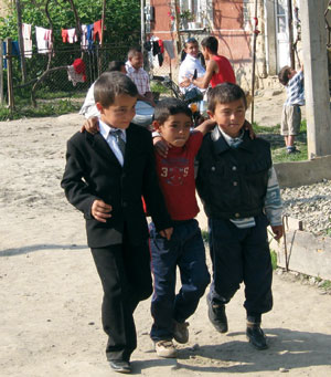 Three boys at an outdoor Reformed Church service in a Roma village in Ukraine