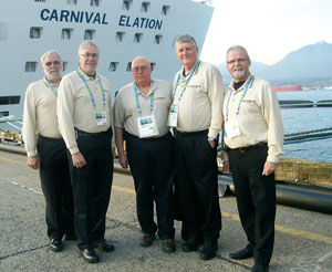RCMP chaplains, including Presbyterian Chuck Congram (second from right) pose in front of their Olympic residence—a cruise ship. 