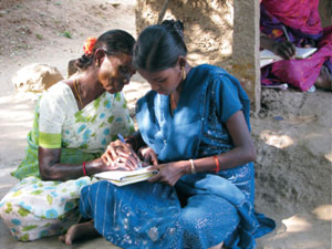 Deivananagi helps teach her elderly neighbours, as well as children, how to read and write. Photo by Guy Smagghe.