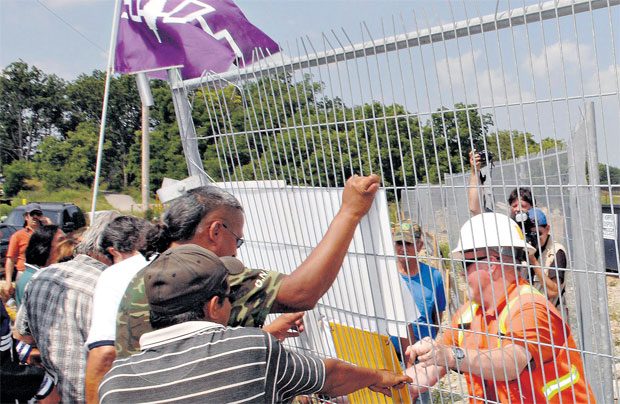 A representative of STM Construction tried to stop native protesters from taking down a locked gate in Brantford, July 2007. Photo by CP Images / The Canadian Press / The Expositor - Brian Thompson.