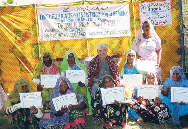 Bill McKelvie with a graduating class of traditional birth attendants. These village women are leaders in their communities, equipped to deliver babies safely and hygienically.