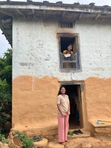 Two women looking out from building