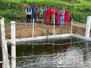 Group beside fenced water