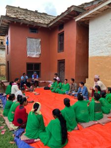 Seated group on orange blanket