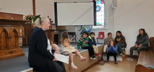 Terry teaching the congregation and children